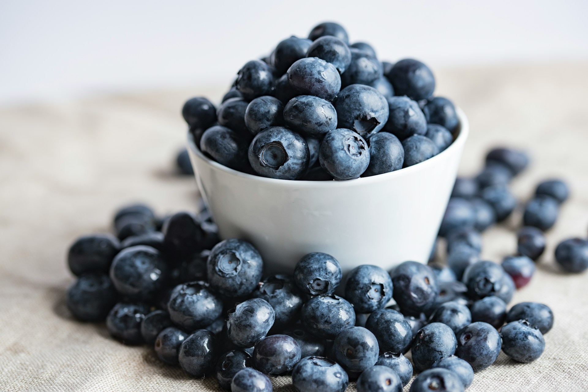 An overfilled bowl of blueberries