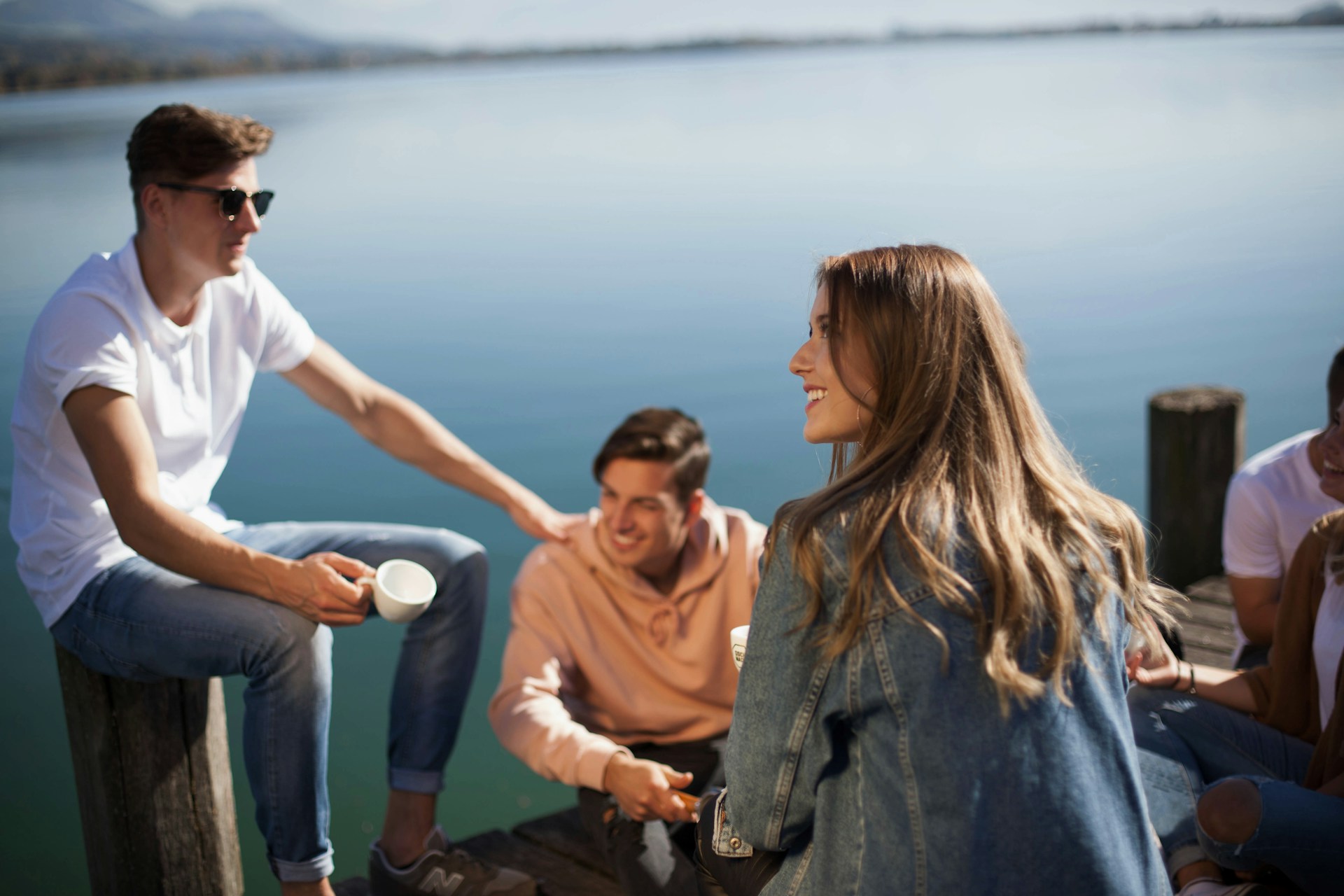 A group of friends smiling on a pier