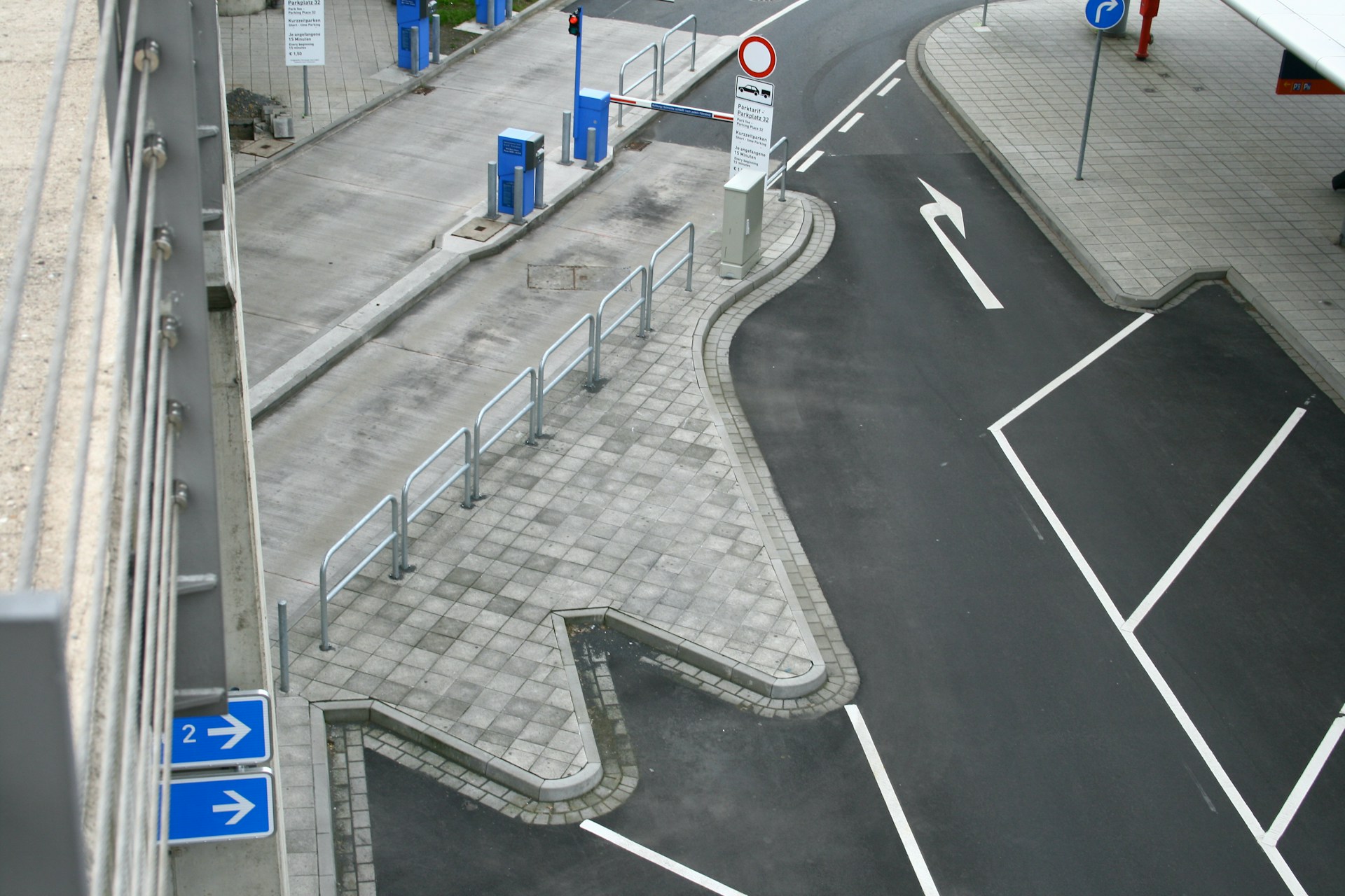 A parking lot entrance with road markings