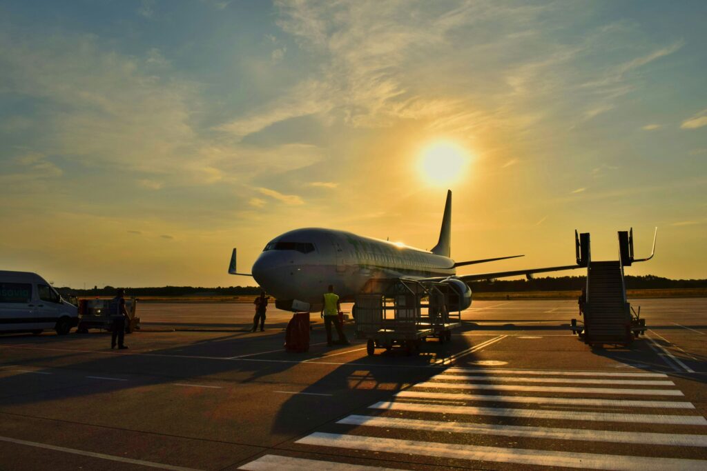 plane on runway at sunset