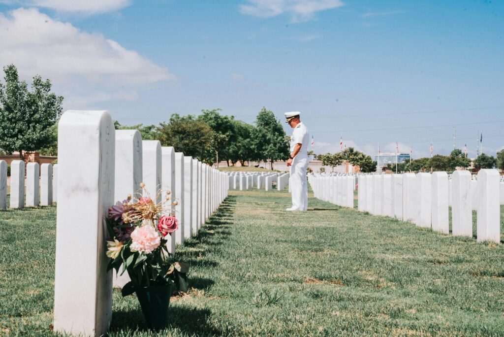 Servicemen paying respect at cemetery