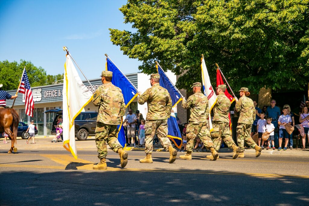 Military Service members carry flags during a 4th of July parade in Miles City, Montana