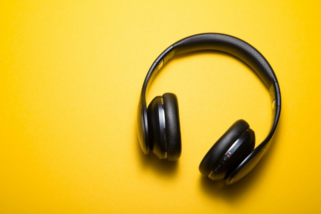 A pair of headphones against a yellow background
