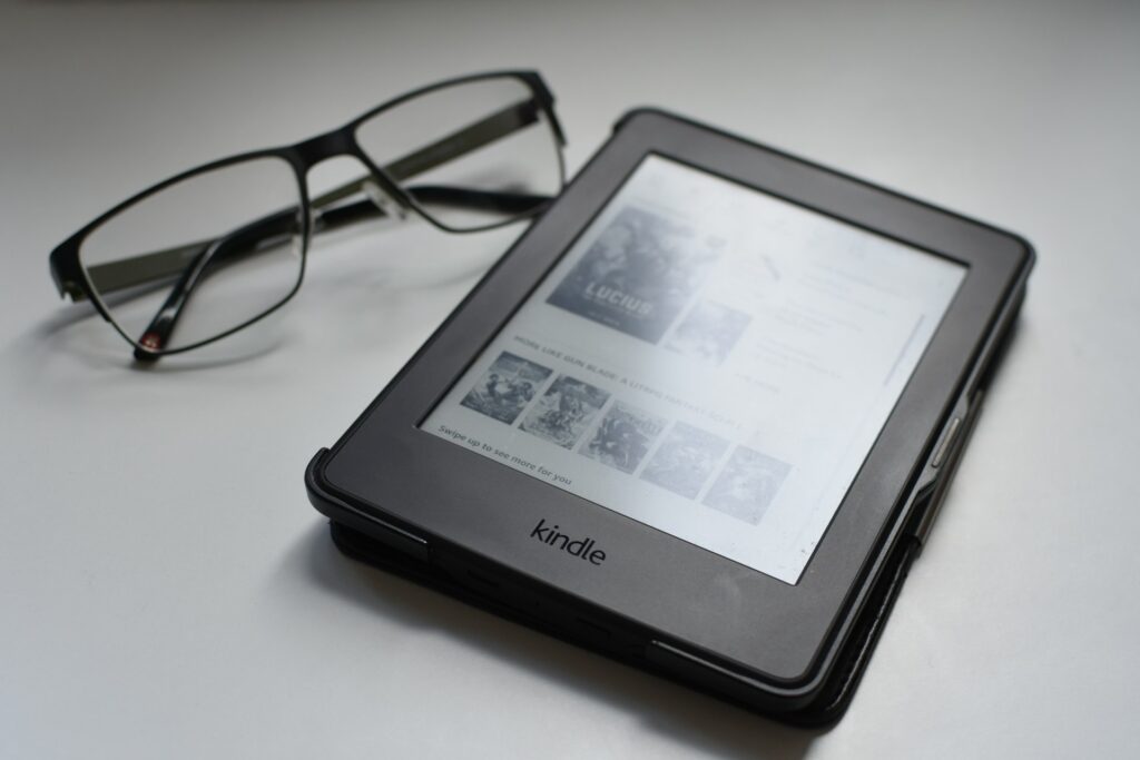 A black kindle e-reader on a tabletop