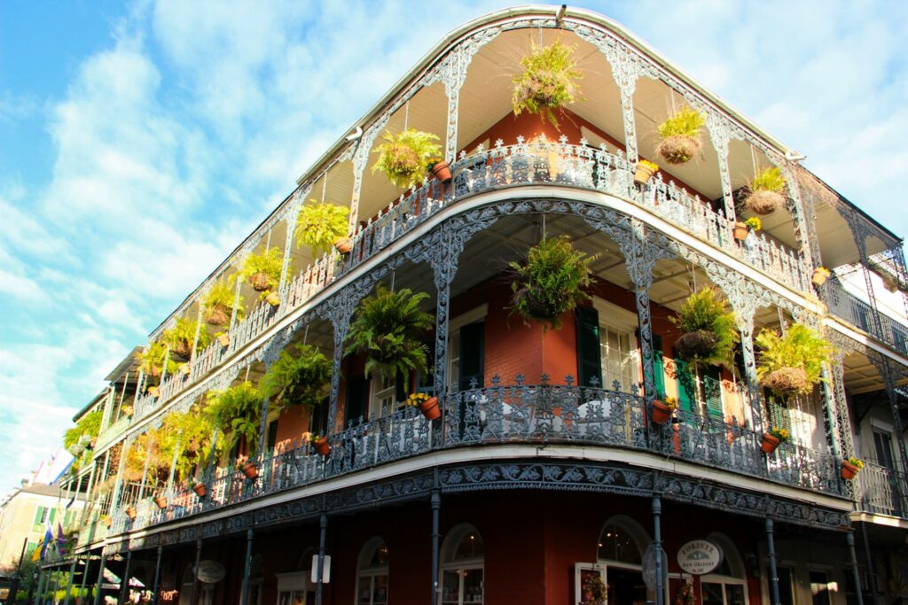 A building in New Orleans with plants on the balconies