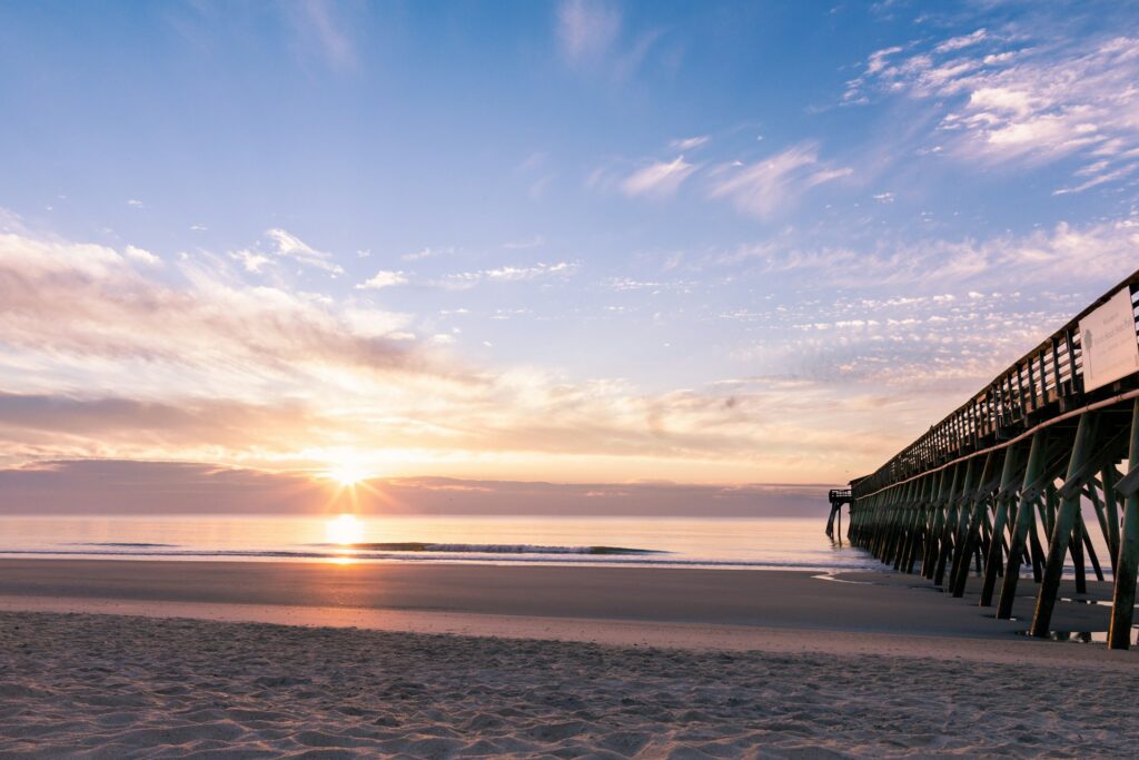 silhouette photography of wooden pier near sunrise