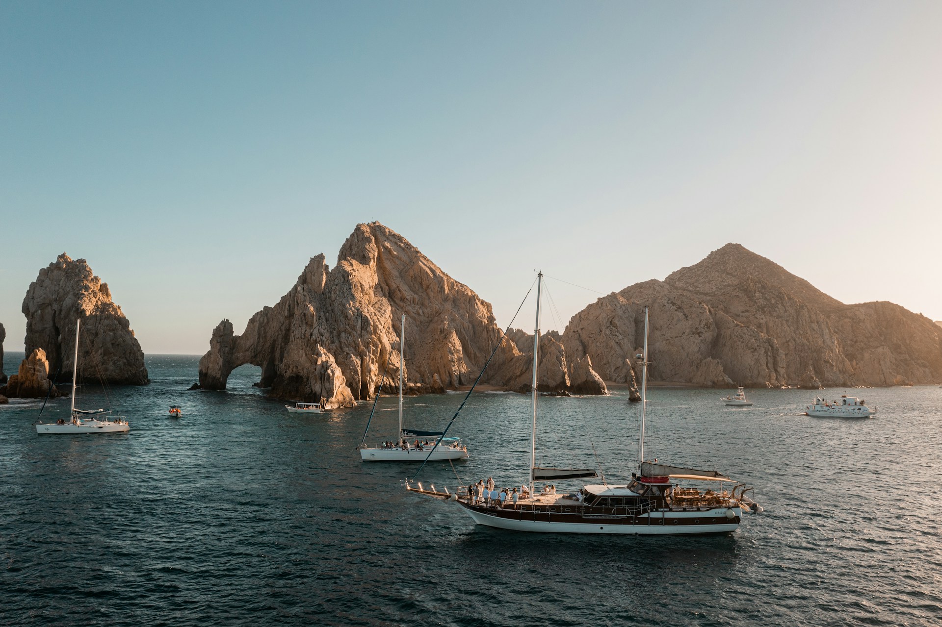 A rocky beach with yachts in Cabo San Lucas