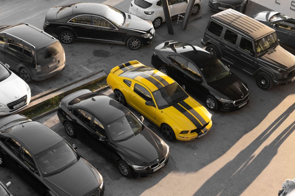 An overhead shot of a parking lot with high end cars